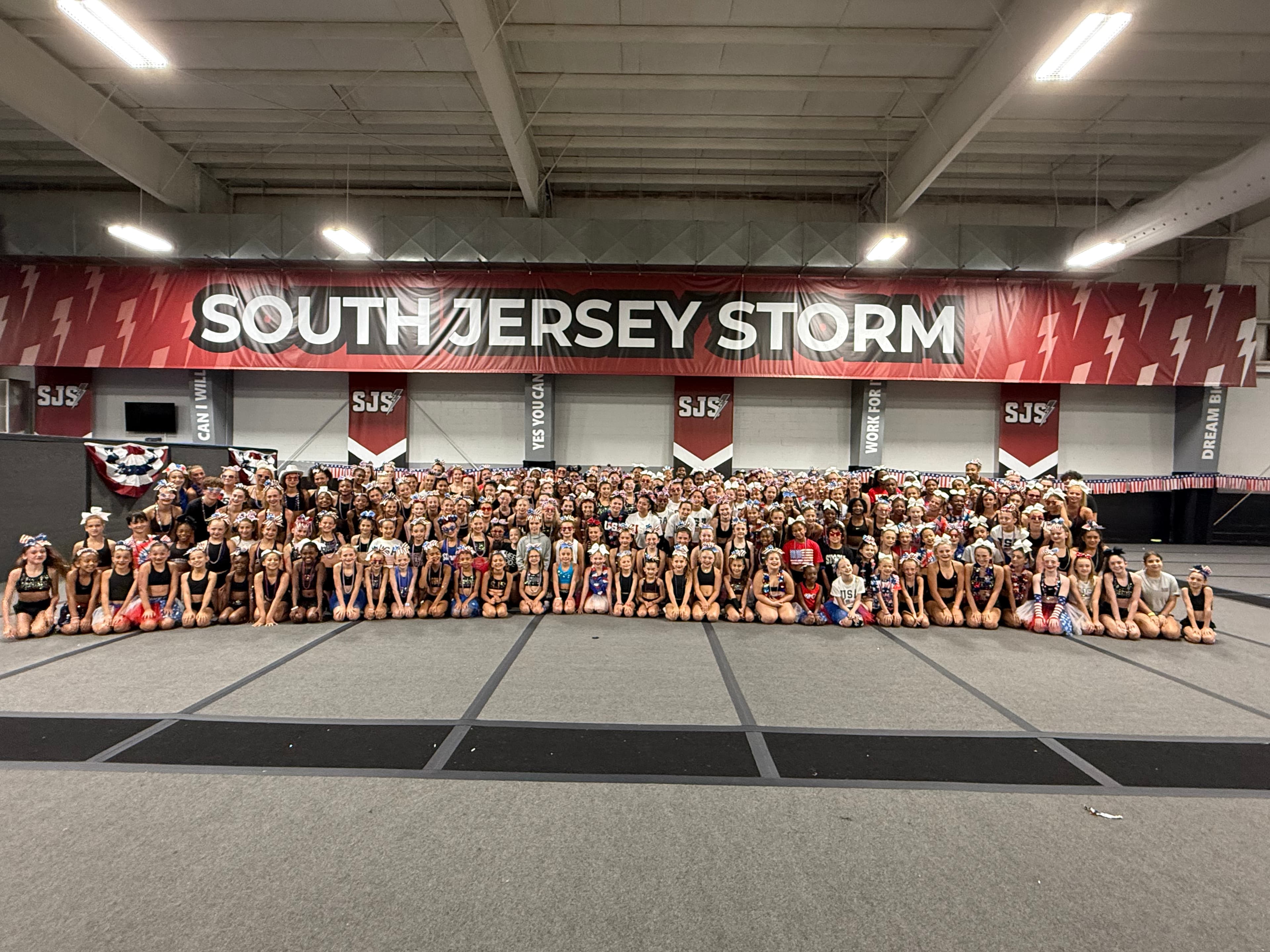 South Jersey Storm athletes gathered on the gym floor beneath the South Jersey Storm banner